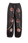 Black pants with colorful spiral patterns on a white background